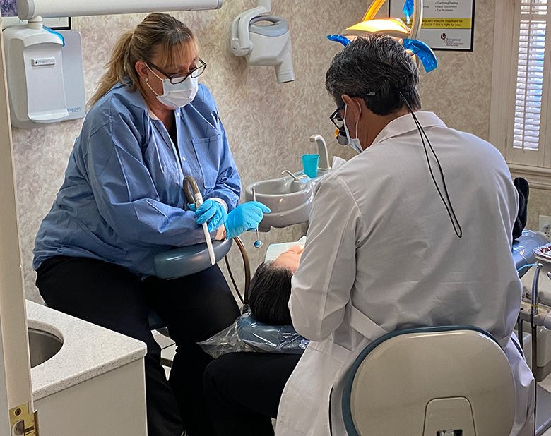 Dr. Boardman and Karin performing a dental treatment - Ridgewood Dentistry, NJ